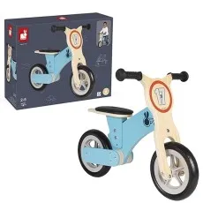 A light blue and wood Janod balance bike with the number 17 on the front, standing next to its box.