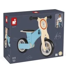 A Janod balance bike and its dark blue product box with illustrations of the bike and a child