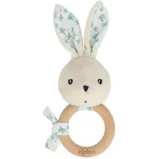 A plush Kaloo rabbit rattle with a wooden ring, featuring a light-colored fabric with a bird pattern