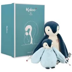 A set of two Kaloo plush penguins, a dark blue parent and a light blue baby, next to a large blue gift box