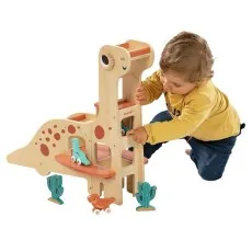 A toddler on their knees plays with a large wooden dinosaur toy with a ramp and other pieces.