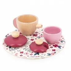 A wooden Janod tea set with a pink teapot, teacups, and a floral-patterned tray.