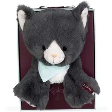 A gray and white kitten plushie is displayed in its box, with a small brand tag on its paw.