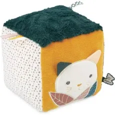 A plush toy block with a spotted side, a ribbed mustard-yellow side, and a dark green top.