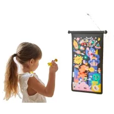 A girl in a white shirt and pigtail plays a superhero-themed velcro dart game.