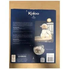 A Kaloo toy box showing a plush sheep and an image of the toy hanging in a crib.