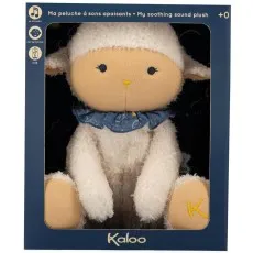 A white plush sheep toy with a blue collar, packaged in a dark blue Kaloo brand box