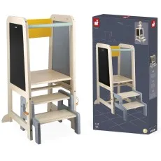 A wooden Janod learning tower with a gray, yellow, and black chalkboard side, next to its product box