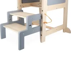 A close-up of a child playing with a wooden toy dinosaur, with a hand on the eye gear.