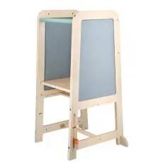A light wood child's learning tower with two grey chalkboard panels and a mint green bar.