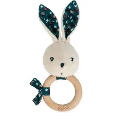 A white plush bunny rattle with a wooden ring and ears with a dark teal and floral pattern