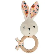 A Kaloo plush bunny rattle with a wooden ring and ears with a floral pattern.