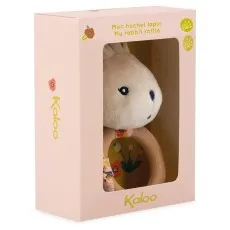A baby rattle featuring a plush bunny head and a wooden ring, in its BOX