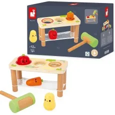 A wooden hammer bench with vegetable-shaped pegs and a mallet next to its product box.