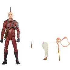 An action figure with a red mohawk in a maroon jumpsuit, with a dagger and an extra arm