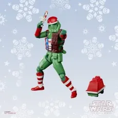 A Star Wars Imperial Stormtrooper action figure in a green and red holiday uniform, holding a white blaster rifle against a snowy background.