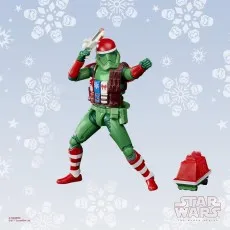 Holiday Stormtrooper action figure from the Star Wars Black Series, posed dynamically, with a red droid and snowflakes in the background.