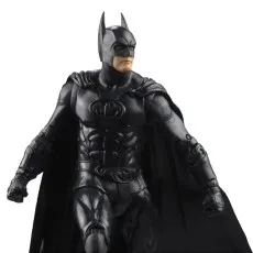 A close-up of a Batman action figure with a black suit and cape.