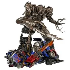 A collectible statue of Megatron from Transformers, with one foot on a broken Optimus Prime.