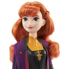 A close-up of a doll of Anna from Disney's Frozen 2 with red hair and a purple coat.