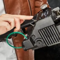 A person's finger points to a toggle switch on a Ghostbusters Proton Pack wand