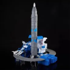 A detailed Transformers rocket tower playset with a gray rocket, a blue base, and a white tank vehicle