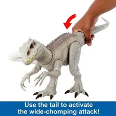 A hand holding an Indominus Rex toy by the tail, with an arrow pointing to the activation motion.