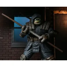 An action figure of a Ninja Turtle wearing an armored robe, holding a staff.