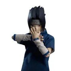 A close-up of a Sasuke action figure with red eyes, posed to perform a hand sign