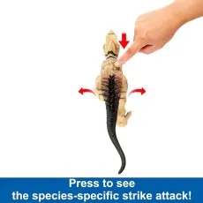 A hand presses the back of a dinosaur toy to activate its species-specific strike attack