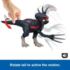 A hand rotates the tail of a Therizinosaurus toy to activate its slashing motion