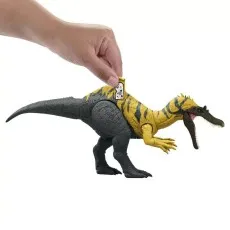 A hand lifts the back plate of a dinosaur toy to reveal a tracking code