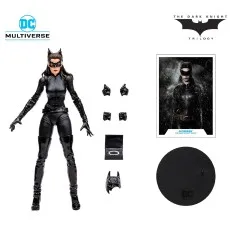 A DC Multiverse Catwoman action figure and her box with accessories and a collectible card.
