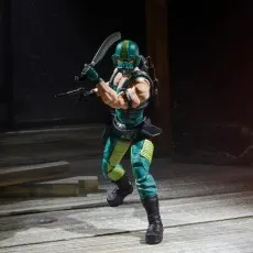 A G.I. Joe Cobra Copperhead action figure holding a machete and a gun, posed in a dark room.