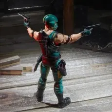 A G.I. Joe Cobra Copperhead action figure holding two pistols, posed from a rear angle.