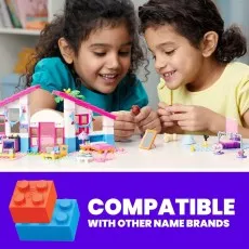 Two girls playing with the MEGA Barbie Malibu House set, with a note about its compatibility