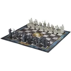 A high-angle view of The Lord of the Rings chess set on a white background, showing all the pieces in their starting positions