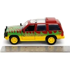 A side view of a Jurassic Park toy car next to a ruler, showing its size