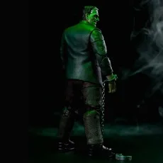 A Frankenstein monster action figure is shown from the back, wearing a chain on its wrist with a single handcuff.