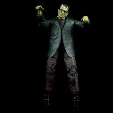 An action figure of Frankenstein's monster with its arms raised against a black background.