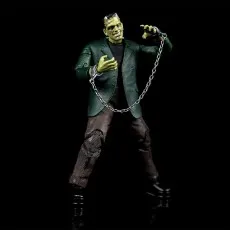 The Frankenstein's monster action figure is posed, holding a chain with handcuffs on a black background.