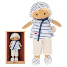 A Kaloo brand doll, in a sailor outfit with a red fish detail and matching hat.