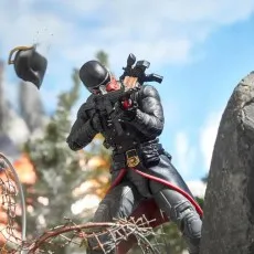 A Cobra Iron Grenadier figure is posed in a battle scene, firing a gun with his helmet flying off