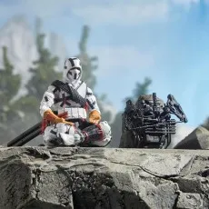 A Storm Shadow action figure is posed in a meditative stance on a rock, with his bow and quiver next to him