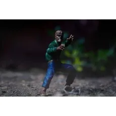 A Universal Monsters Wolfman action figure crouching on a dirt path with a trap nearby.