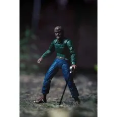 The NECA Wolfman figure standing on textured ground, with his cane.