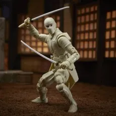 A white-clad Storm Shadow action figure in a crouching stance, wielding two katanas in a diorama setting