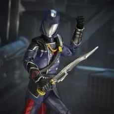 A Cobra Commander action figure in a dark blue uniform is holding a sword