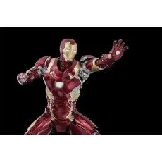 A highly detailed Iron Man action figure with a glowing chest reactor, posing with his palm facing forward.