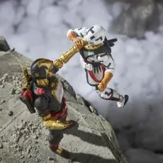 A Cobra Iron Grenadier B.A.T. action figure is fighting a white-suited action figure in a diorama